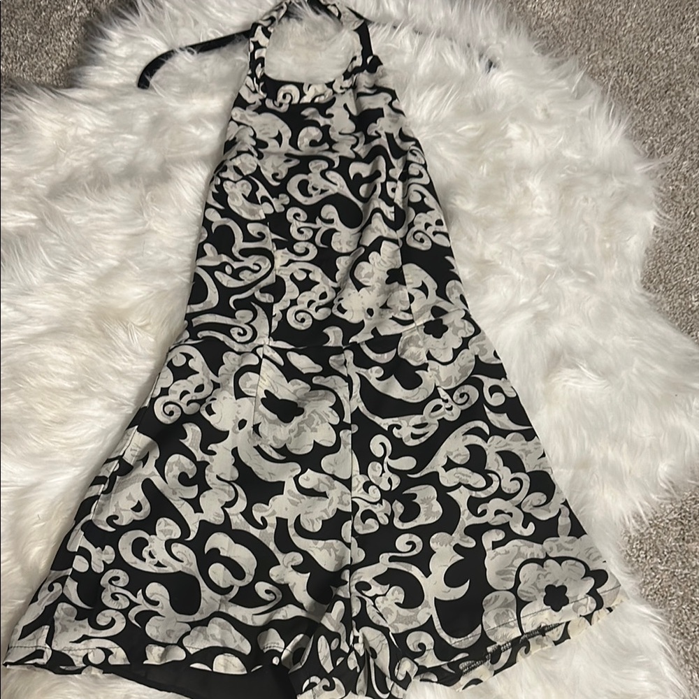 Black and Grayish Undertone Romper with open back and hidden zipper.